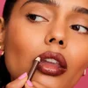Woman applying brown lip liner
