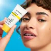 Model Holding Suntouchable Whoa Glow SPF 30