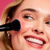 Model Applying Sheer For It Blush Tint Using Brush

