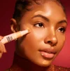 Model Applying Liquid Highlighter To Face