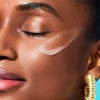 Woman with makeup primer on her cheek