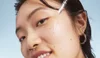 Model applying hyaluronic acid face serum